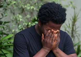 boy with his face in his hands