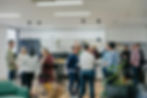 Colleagues socializing in an office kitchen