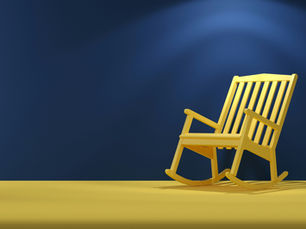 Yellow rocking chair against a blue background