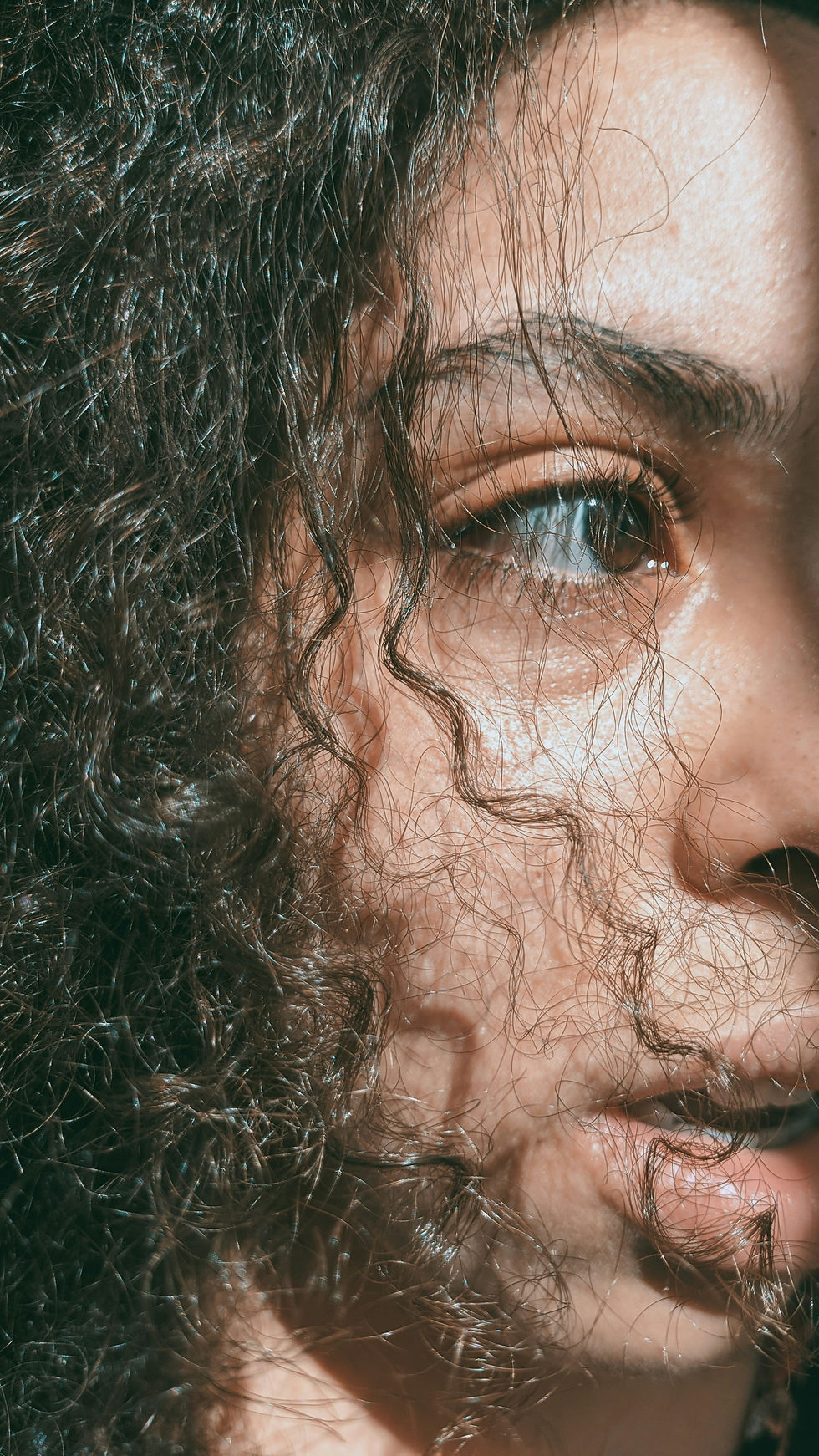 frizzy hair covering face of young lady