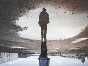 man reflecting in water