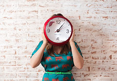 Woman holding a clock, representing time management challenges faced by individuals with ADHD