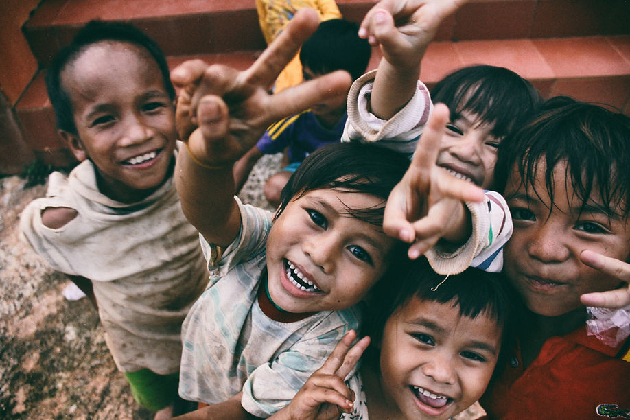 Young impoverished children smiling and laughing