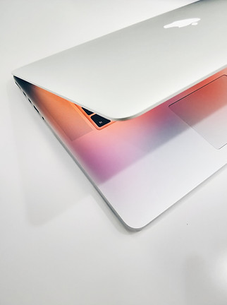 Macbook on a grey backround. shows the astethics of the digital work in terms ob webdesign and online marketing.