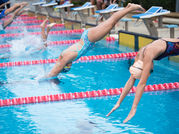 Women diving into a pool