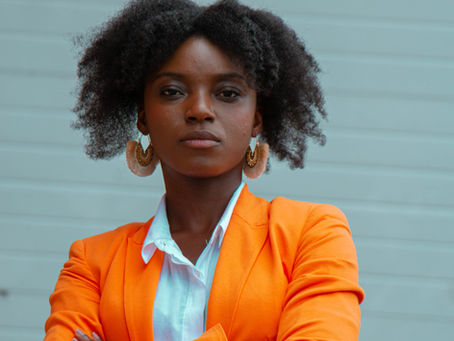 A woman standing in quiet reflection—symbolizing faith, vision, and courage to build even when the path is unclear.