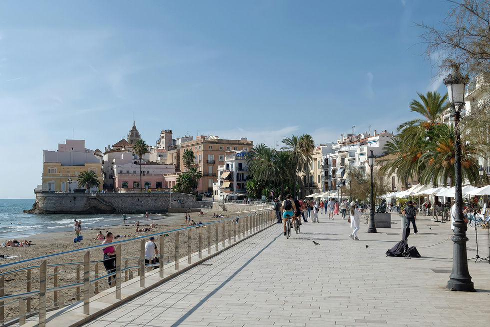 Travelers exploring a sun-drenched Mediterranean waterfront town on an active river cruise excursion
