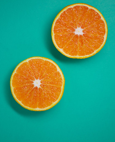 Orange Slices with A Teal Background/Fruit to Help Reduce Stress