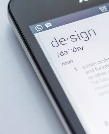 A cellphone displaying the word 'design' and its meaning - Merging creativity and functionality in digital expression