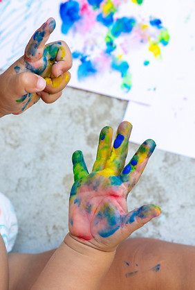 Image of a child's hands covered in paint