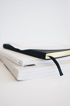 Three notebooks stacked. Cognitive Behaviour Therapy in Oakville Ontario