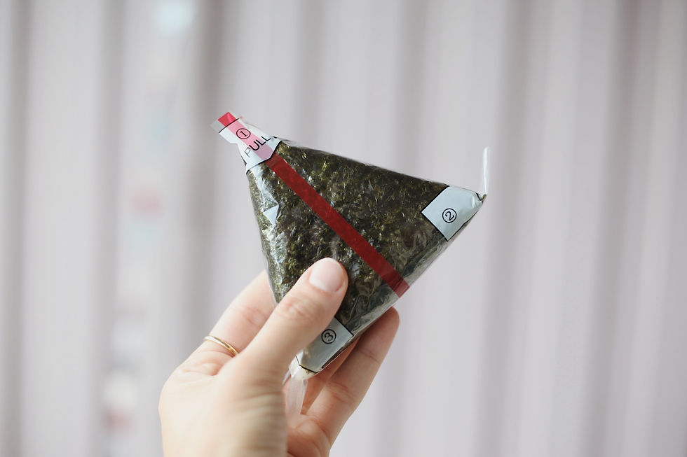 The woman's hand holding onigiri