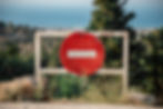 A picture of a no entry sign at the edge of a mountain