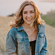 woman in jean jacket smiling