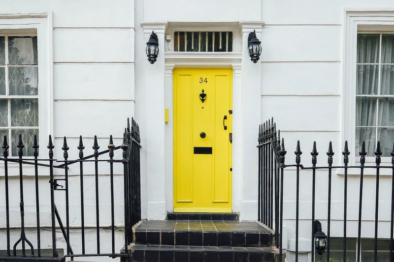 A yellow door in a residential neighborhood