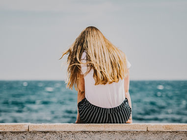 Woman stilling in front of ocean