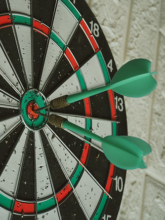 Darboard with dart on bullseye