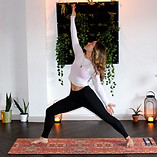 a millennial woman does a private trauma-informed yoga class virtually