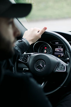 Professional driver and luxurious spacious interior of a black Mercedes-Benz V-Class with premium leather seats, ready for a comfortable long-distance private transfer across Europe by MYEUTAXI