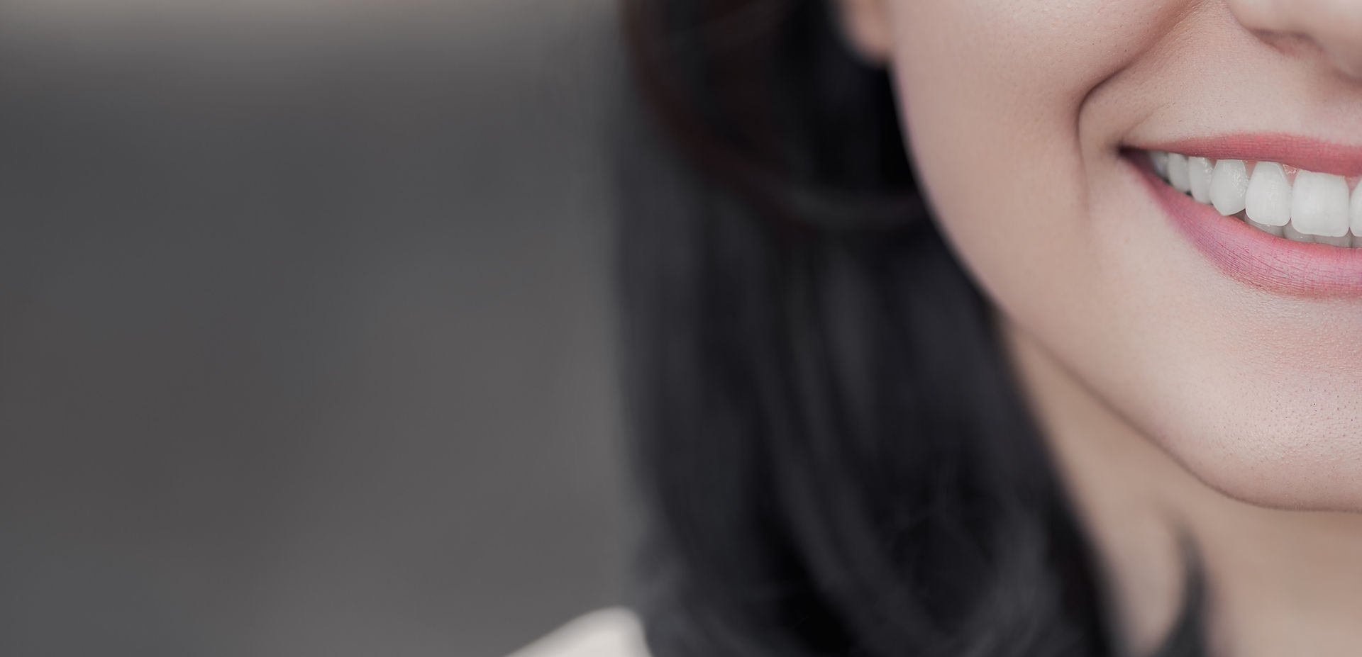 smiling woman with long hair face split by frame