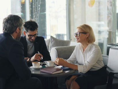 Business professionals engage in a conversation about selling a business.
