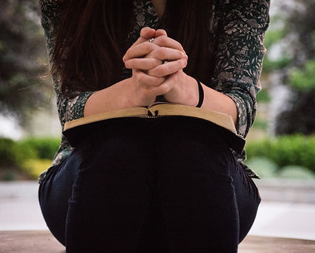 Image of woman kneeling praying