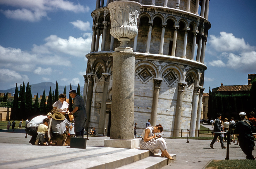 tourists at the base of the Leaning Tower of Pisa