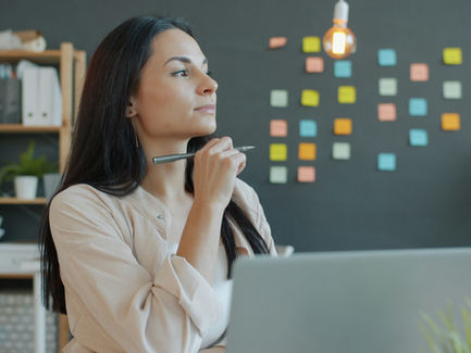 a woman sitting at a desk thinking