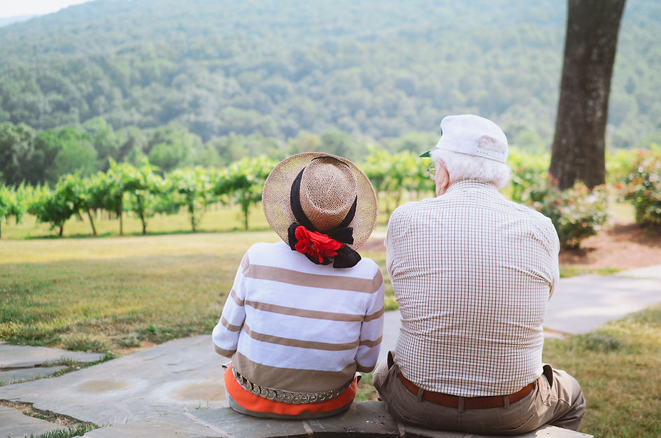 Two seniors sitting on a park bench