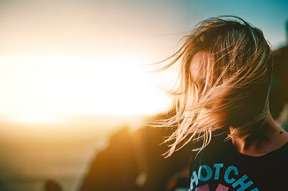 Windblown hair looking at the sea