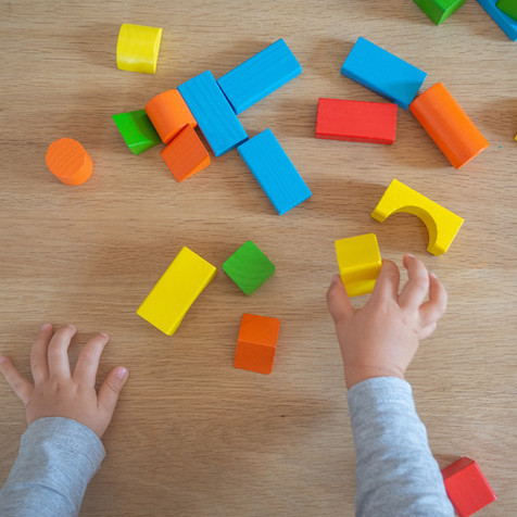 Child playing with colorful blocks