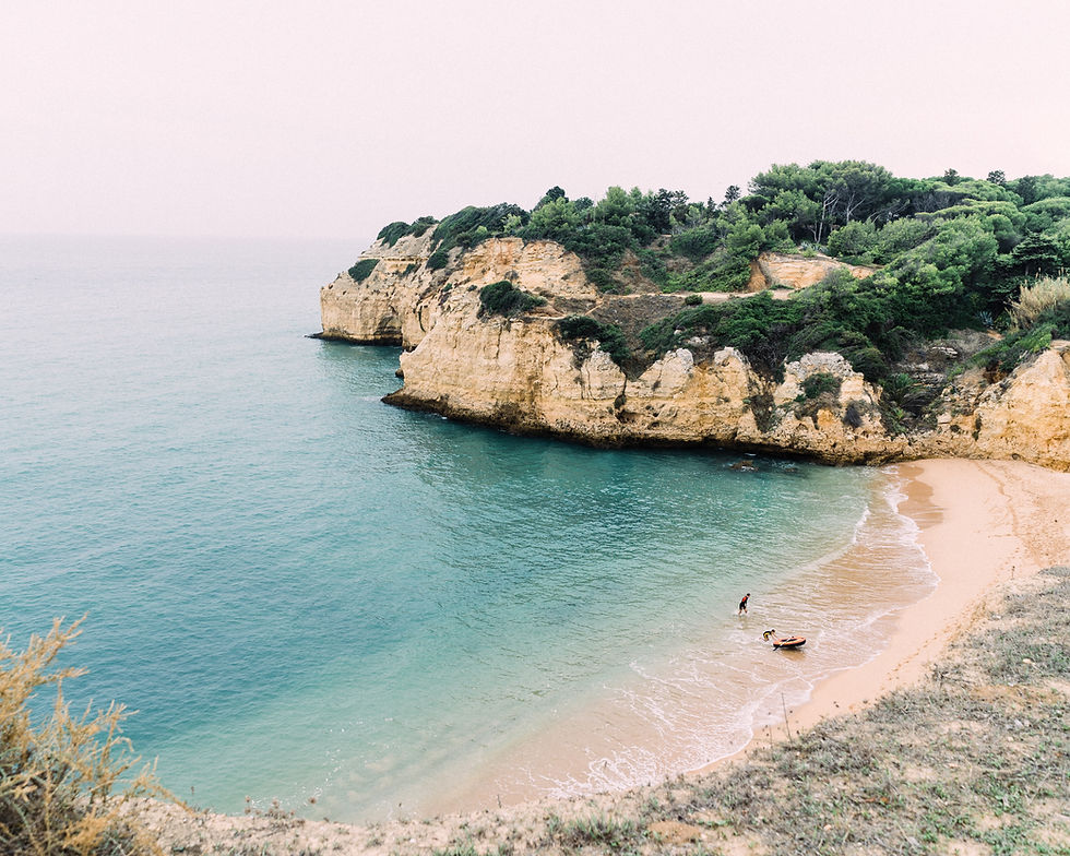 Hided bay flanked by rock formations in the Algarve, Portugal