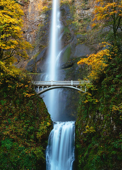 White bridge with waterfall in the background