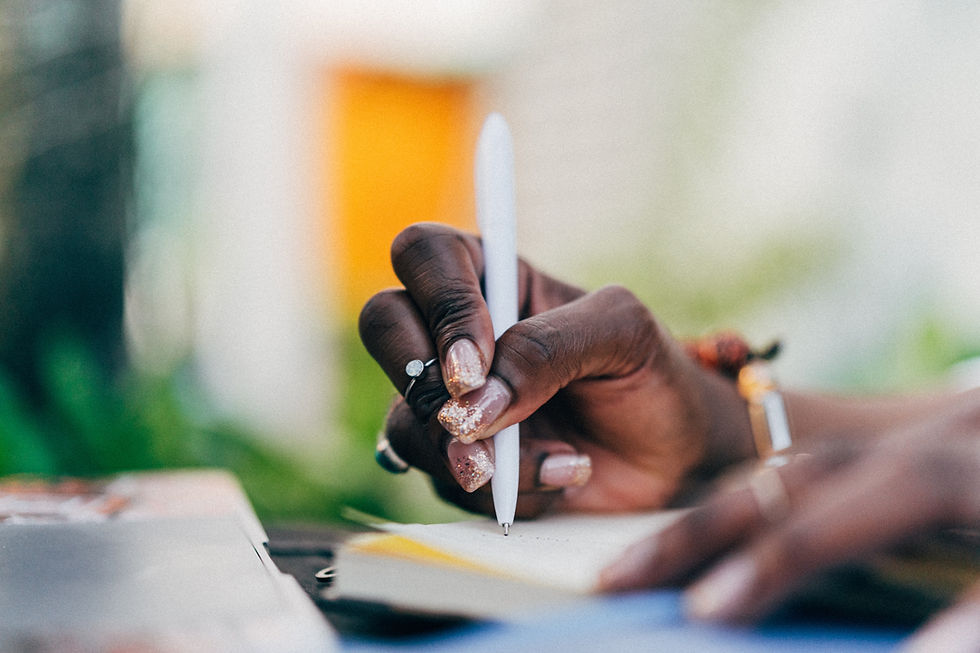 A therapist’s hands holding a pen on a notebook