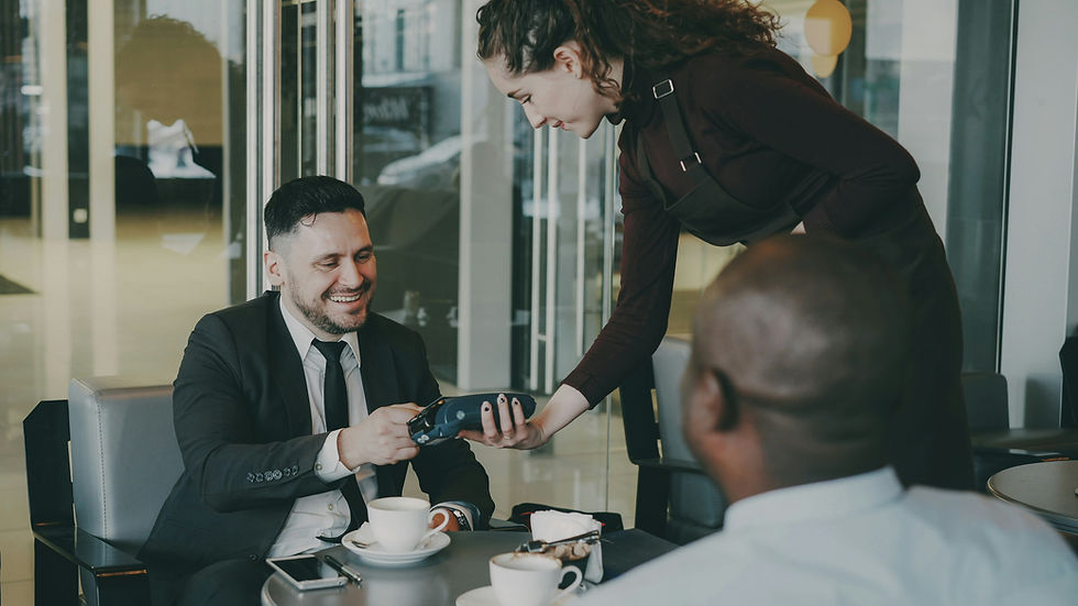 a waitress serving guests at a table asking them for their feedback