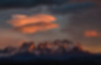 Sunlight sets on on a rocky mountain range.