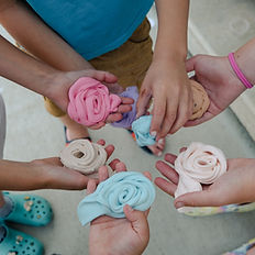 children hands with a variety of slime colours and texture
