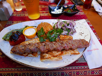 Authentic Egyptian traditional food platter featuring dishes like koshari, falafel, grilled kofta, and fresh pita bread.