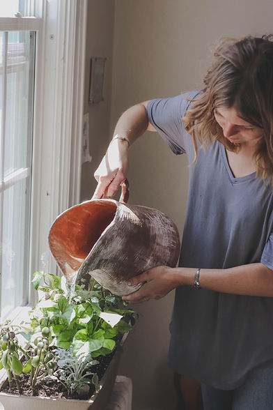 Girl watering a houseplant