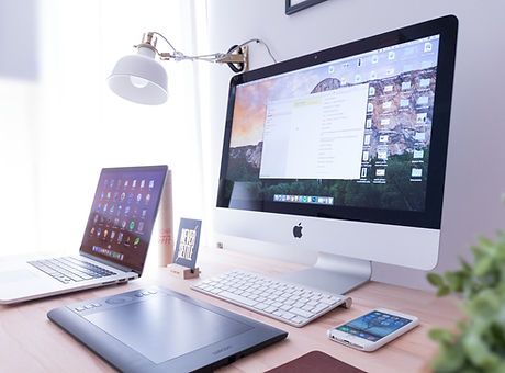 Devices arranged atop a desk