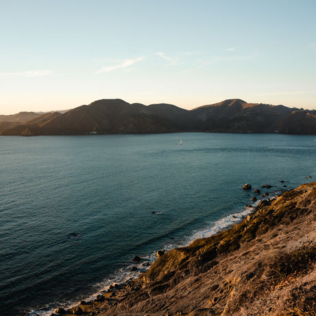 San Francisco Bay with view of the bridge and coastal water shoreline.