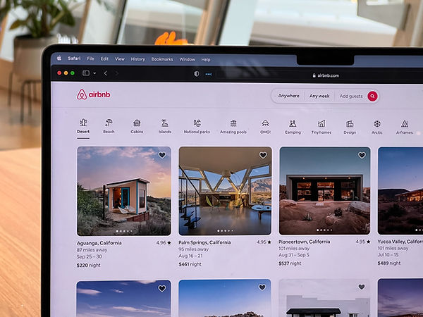Computer with AirBnb listings on it