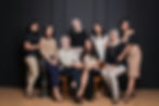 A diverse team of wedding professionals in warm neutrals in a portrait.