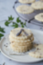 Stacked shortbread cookies on a plate with lavendar