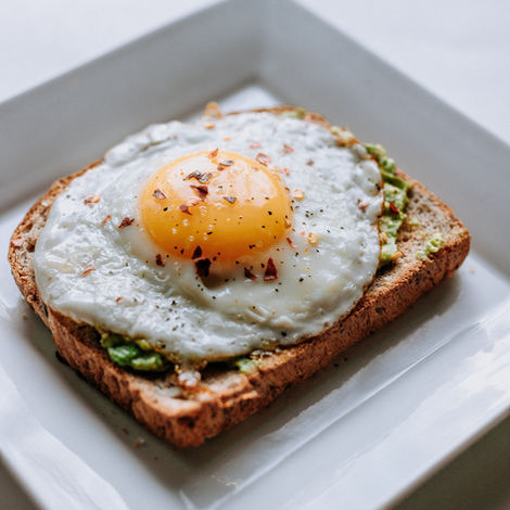 Discover Exquisite Breakfast Catering at Passion Infused Eatery - Indulge in our Signature Toast with Avocado and Sunny Side Up Egg, Seasoned to Perfection for an Unforgettable Flavor Experience!