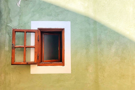 Image of an open door/window against a plain wall
