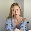 Caucasian woman reflecting quietly at home.