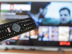 Analyst reviewing streaming TV campaign data and performance charts
