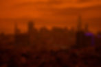 City skyline with orange hazy atmosphere demonstrating urban heat island effect and air quality challenges