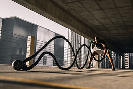 Training with ropes under a bridge, symbolising efficient outdoor workouts.